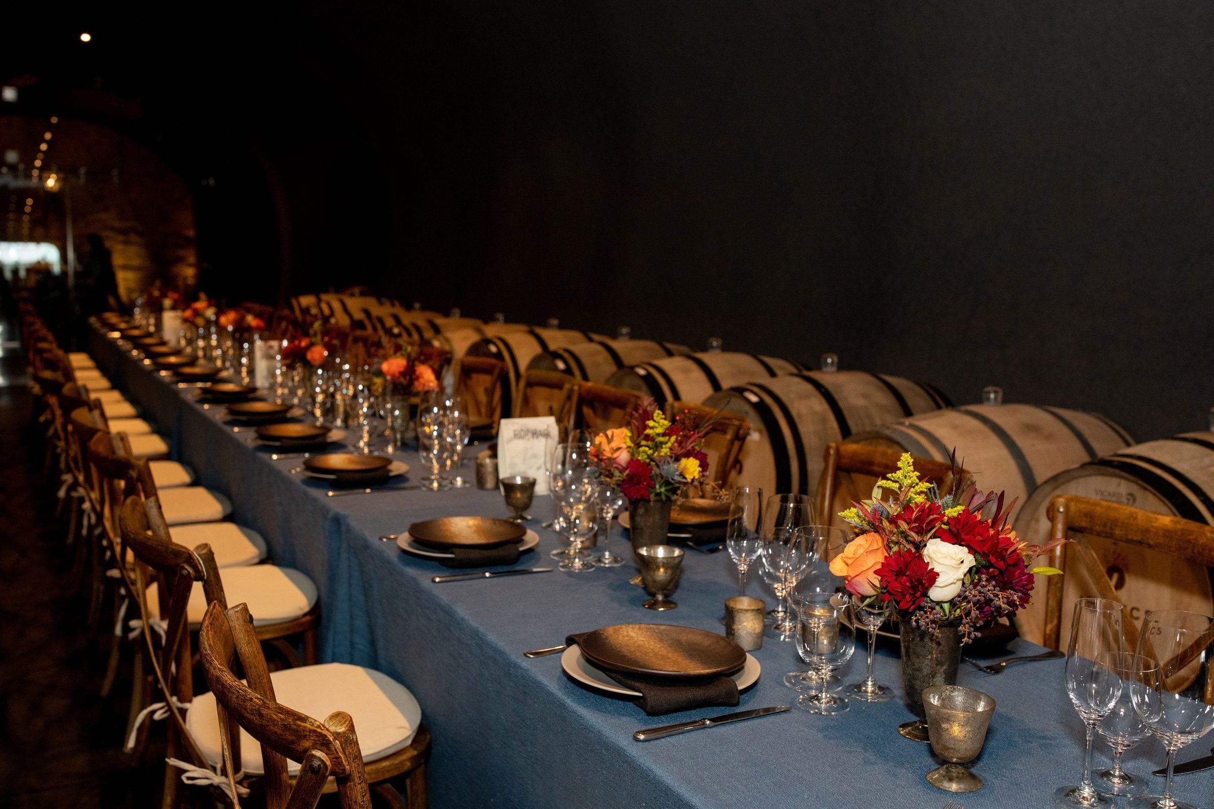 A candlelit reception in a wine barrel room