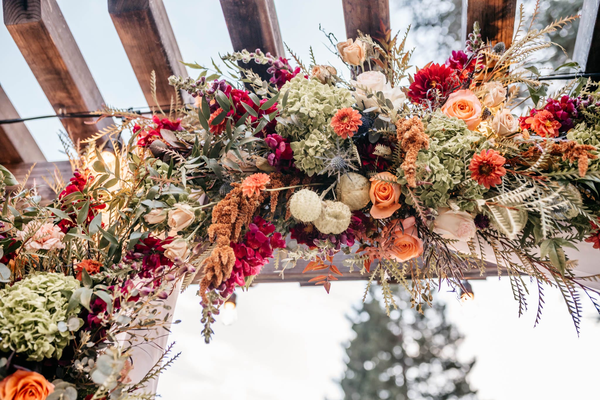 A lush autumn ceremony floral arch