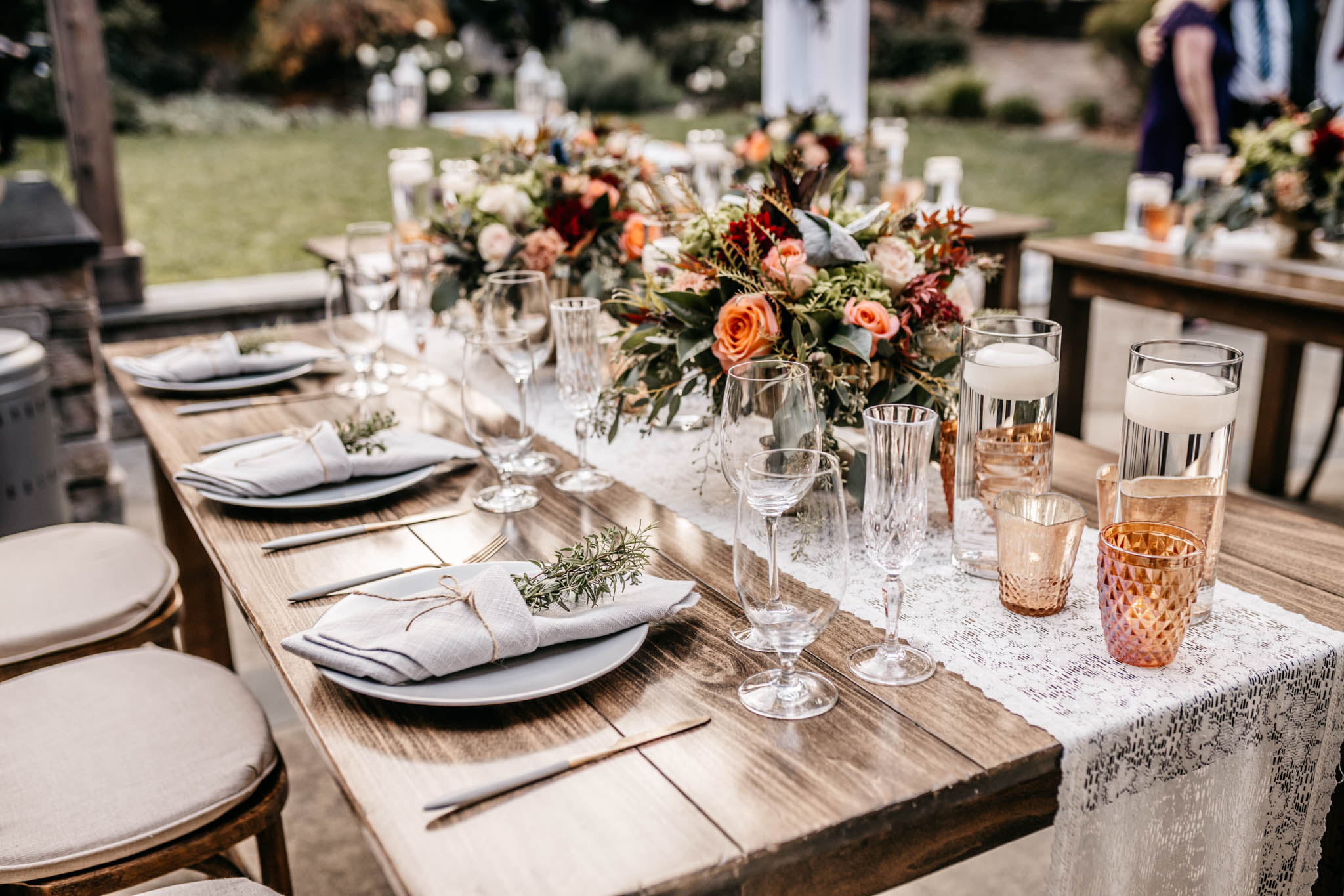 A vineyard wedding reception tablescape at dusk